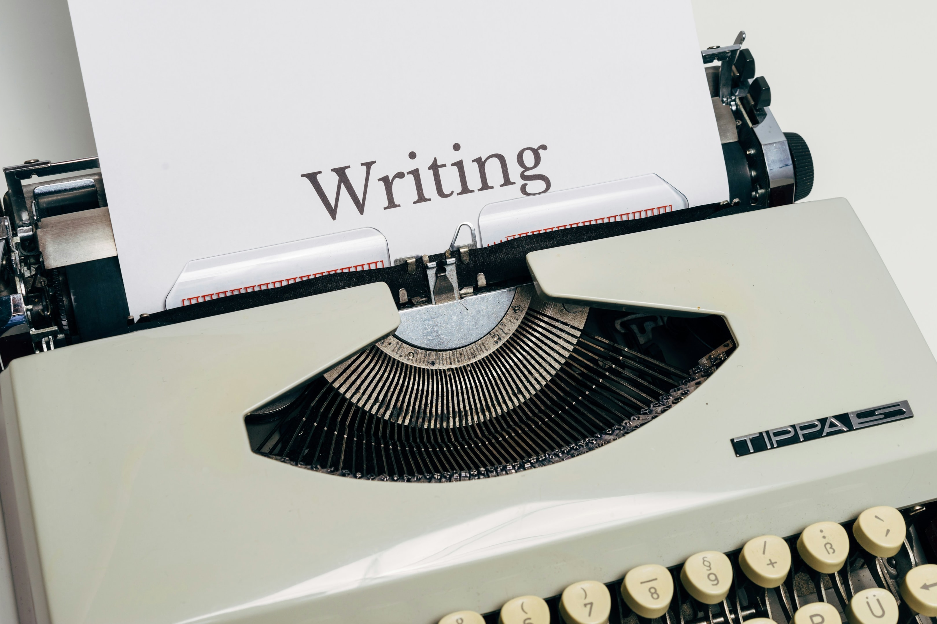 A typewriter with the phrase 'writing skills' representing the idea of writing skills.
