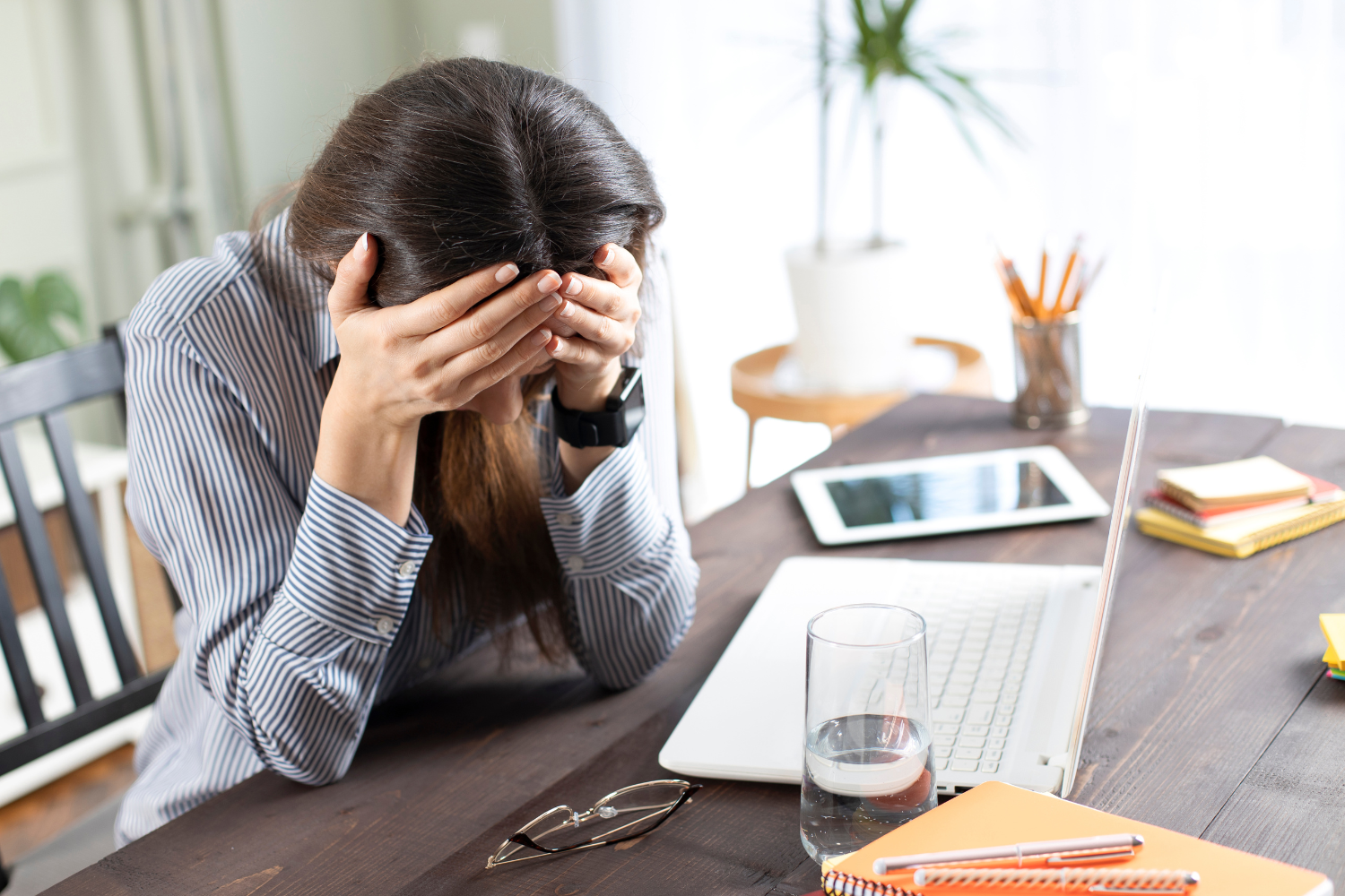 An image of a dehydrated person holding their head.