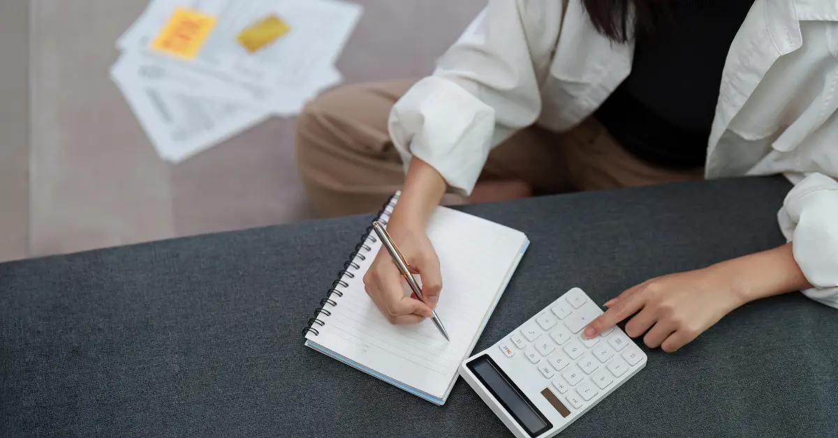 Woman calculating income and understanding S Corp distribution tax rate.