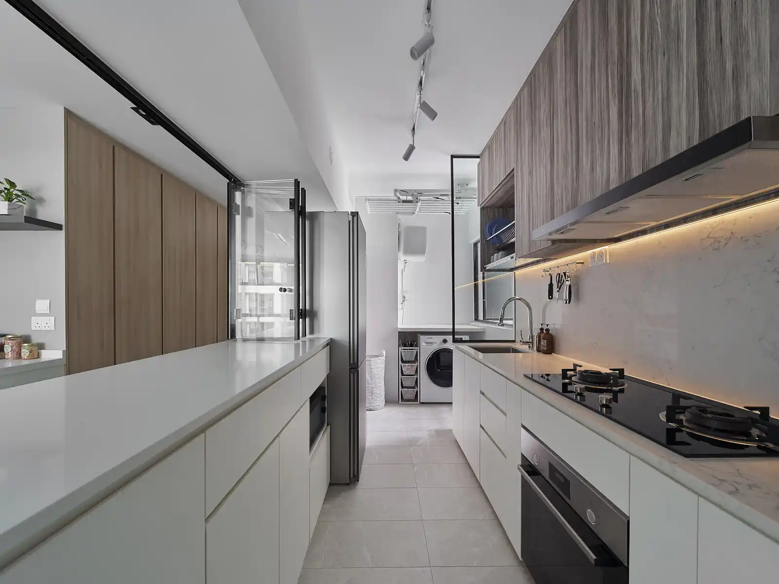 Minimalist house galley kitchen with wood-grain upper cabinets, long counters and concealed laundry