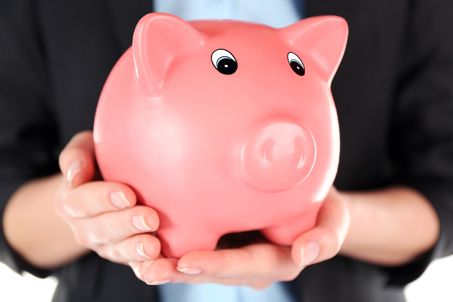 A businessman holding a piggy bank.