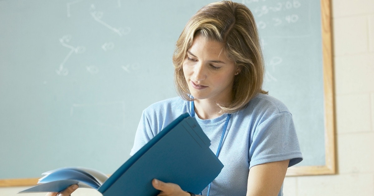 A woman reading about the FICA Social Security tax.