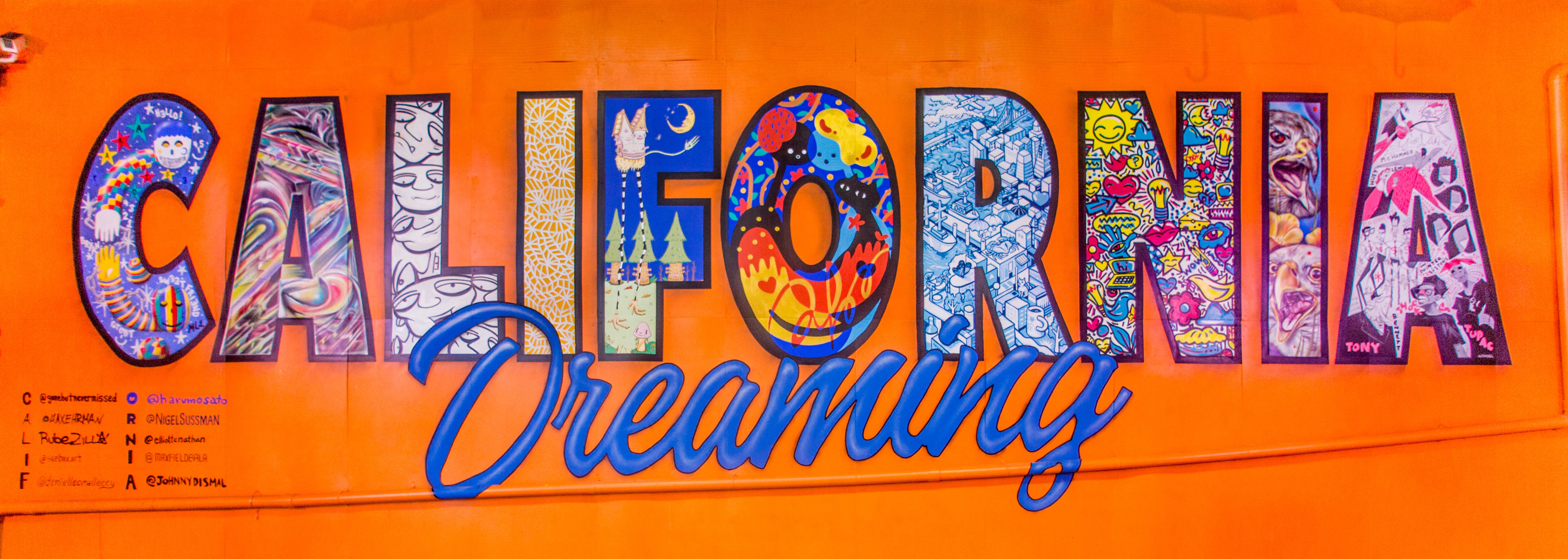 A colorful mural saying "California Dreaming" in the Umbrella Alley, Oakland, CA