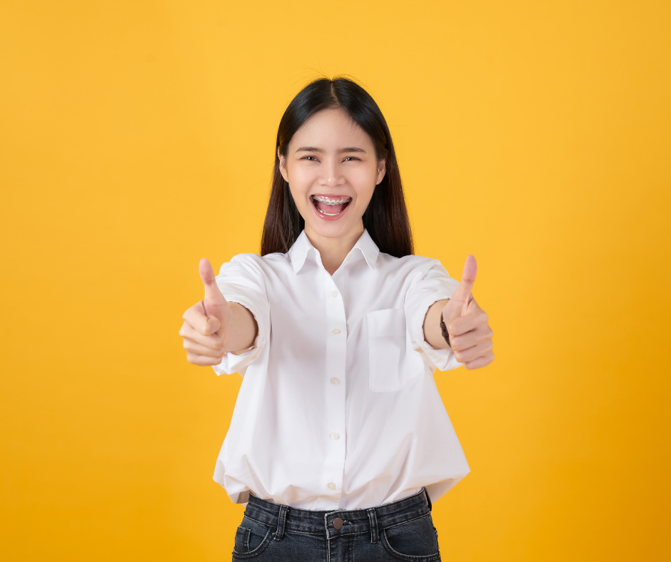 A person celebrating personal stories of triumph with a thumbs up