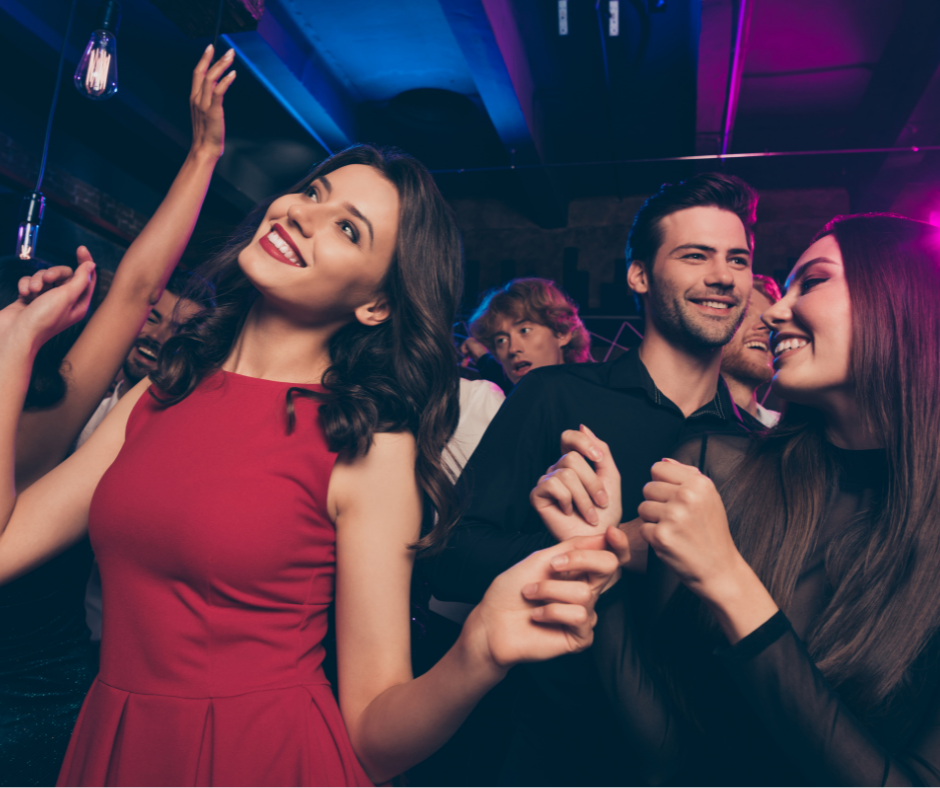 People dancing on a dance floor at a party without drinking alcohol