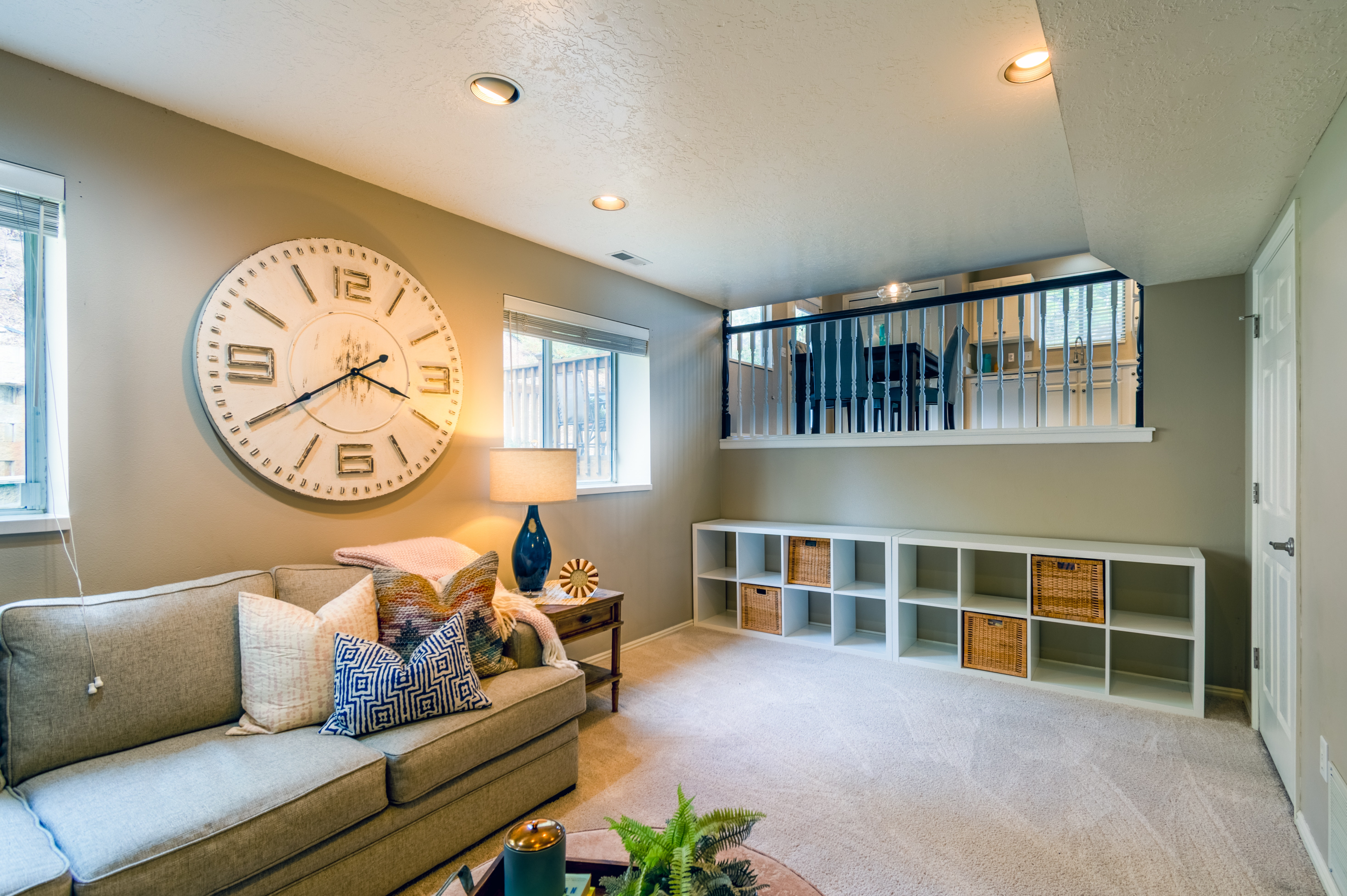 large wall clock and cubbies with baskets