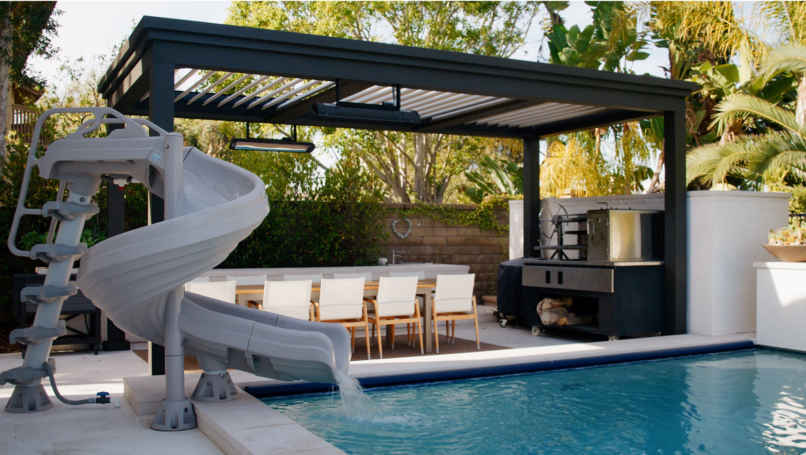 Poolside pergola installed over a patio with a beautiful outdoor kitchen.