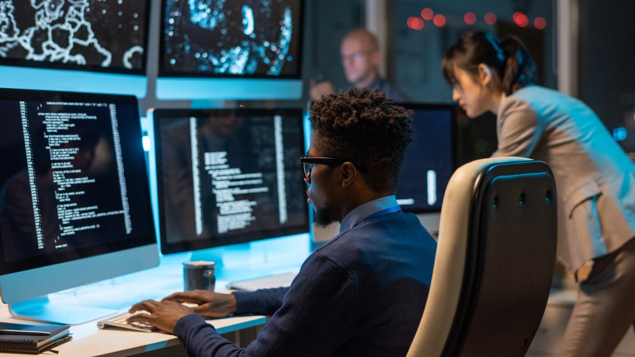 team performing network monitoring on computer screens