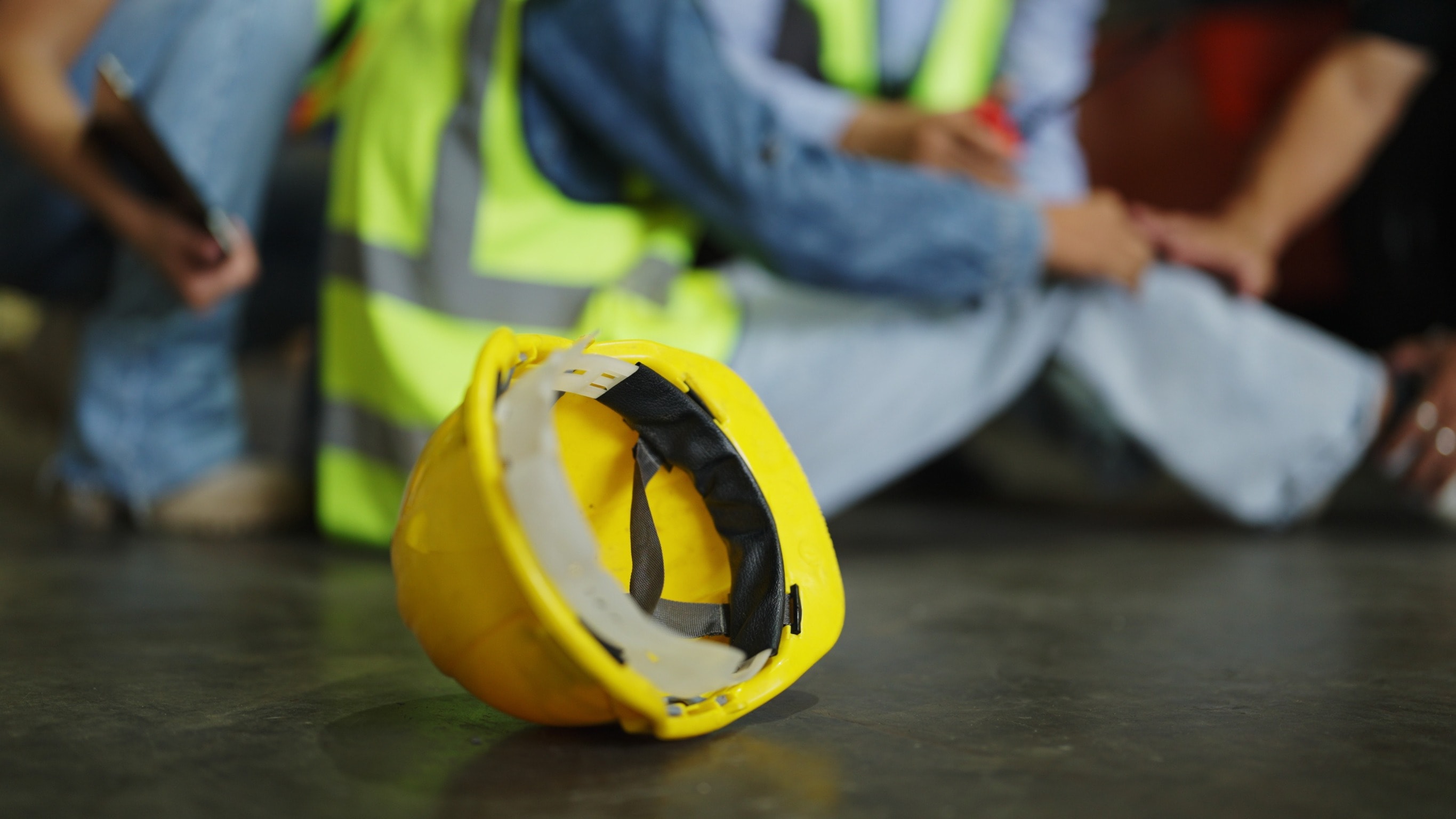 A yellow hardhat lies on the floor after a forklift truck accident