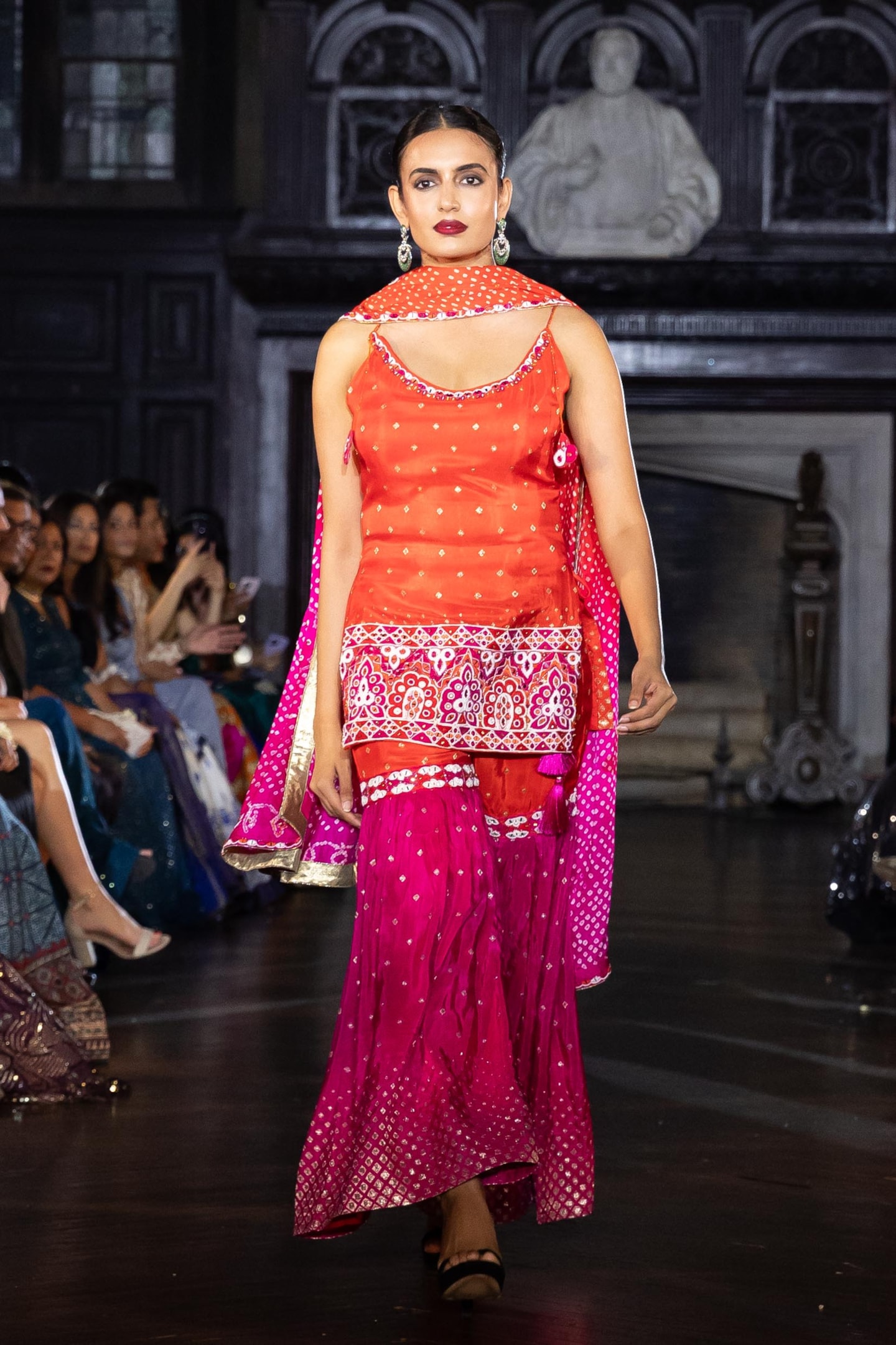 A traditional salwar kameez outfit is elegantly displayed on a wooden mannequin, featuring intricate embroidery and a flowing dupatta that adds a touch of grace. This three-piece ensemble showcases the rich fabrics and styles commonly worn by women in South Asia, making it a perfect choice for special occasions.