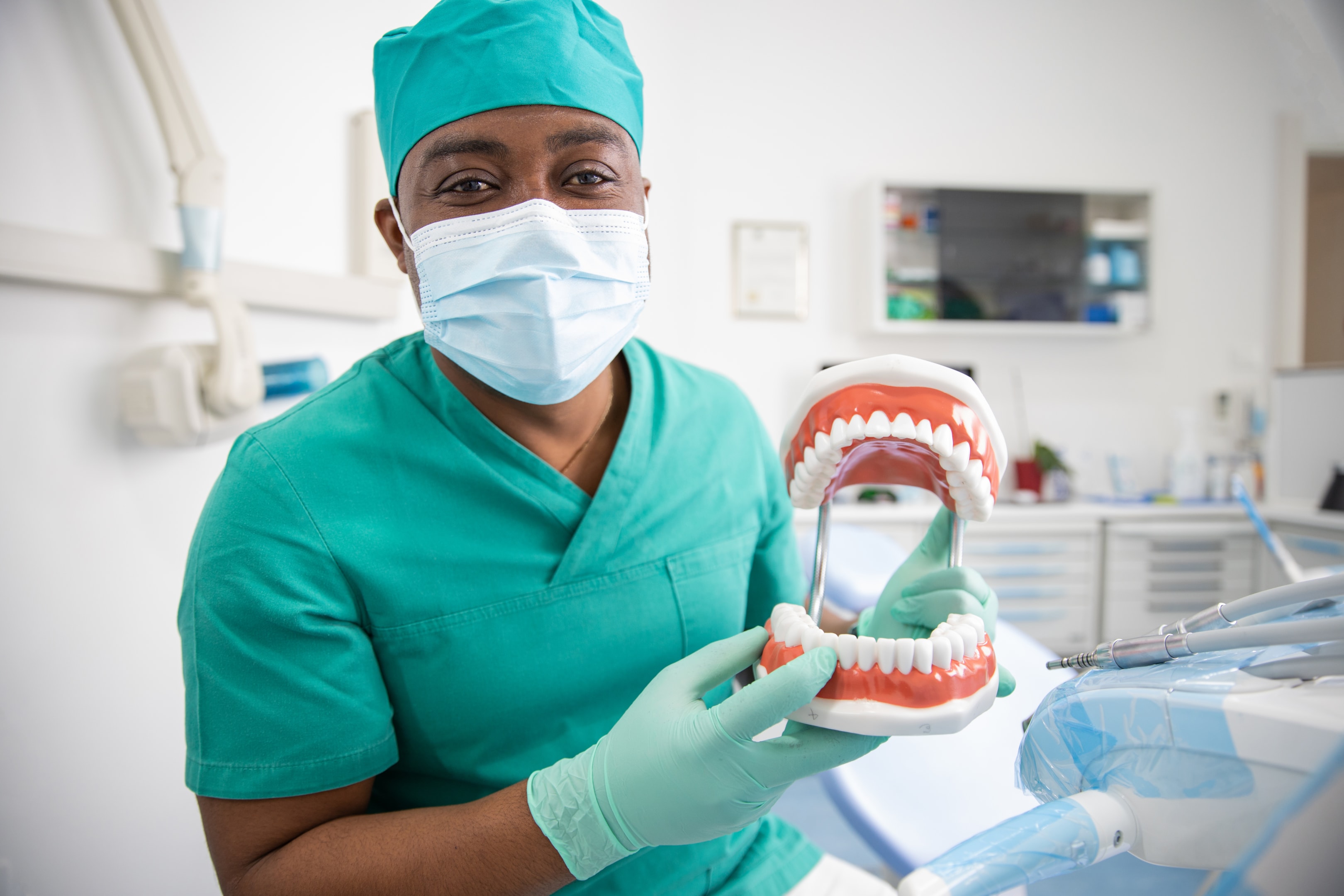 Oral surgeons holding a dental model