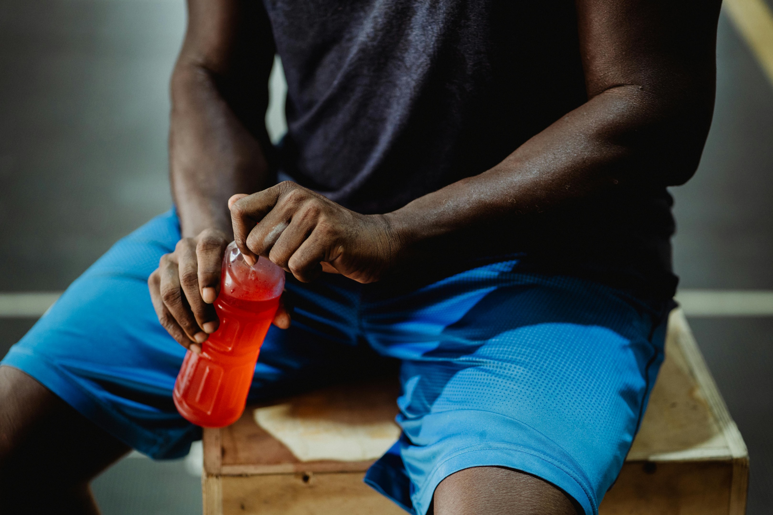 Photo by Ketut Subiyanto: https://www.pexels.com/photo/man-in-black-t-shirt-and-blue-shorts-holding-red-plastic-bottle-4720499/