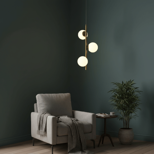 Minimalist bedroom corner with modern globe pendant light above armchair and side table.