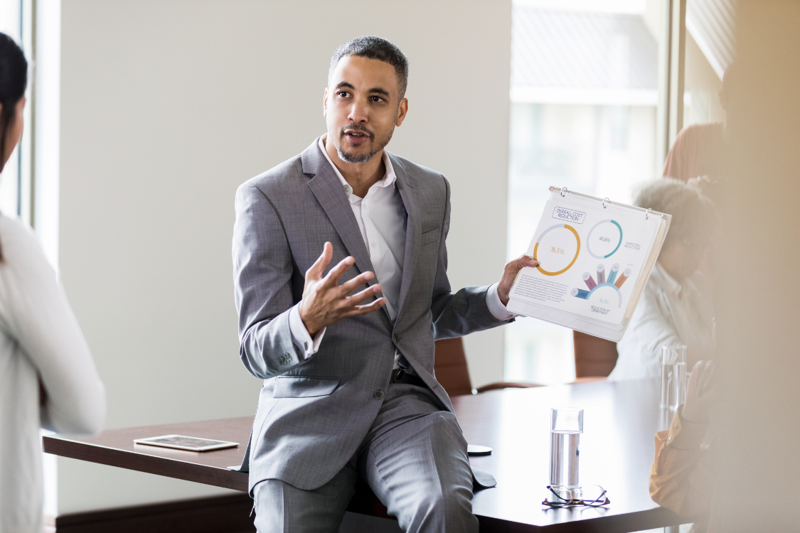 Professional presenting business valuation data and buyer strategy without involving a broker