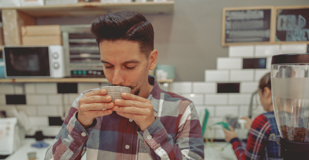 man tasting coffee