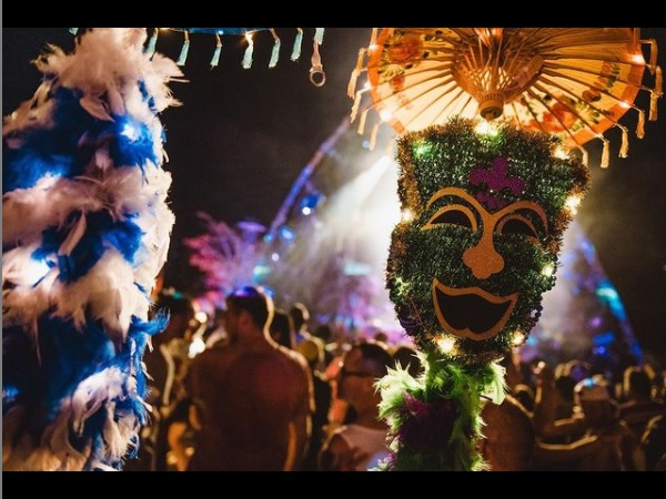 carnival with a large green mask shaped like a happy face