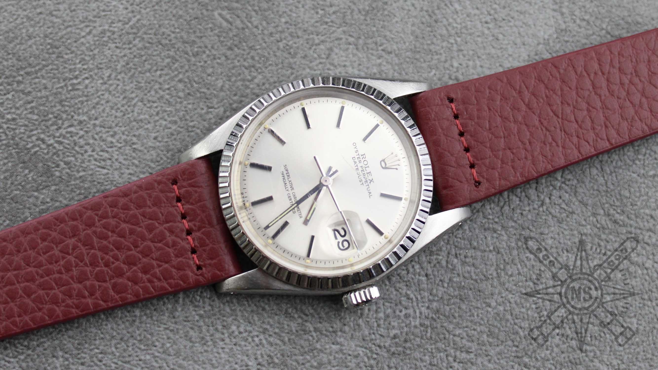 A close-up of a burgundy leather watch strap elegantly displayed.