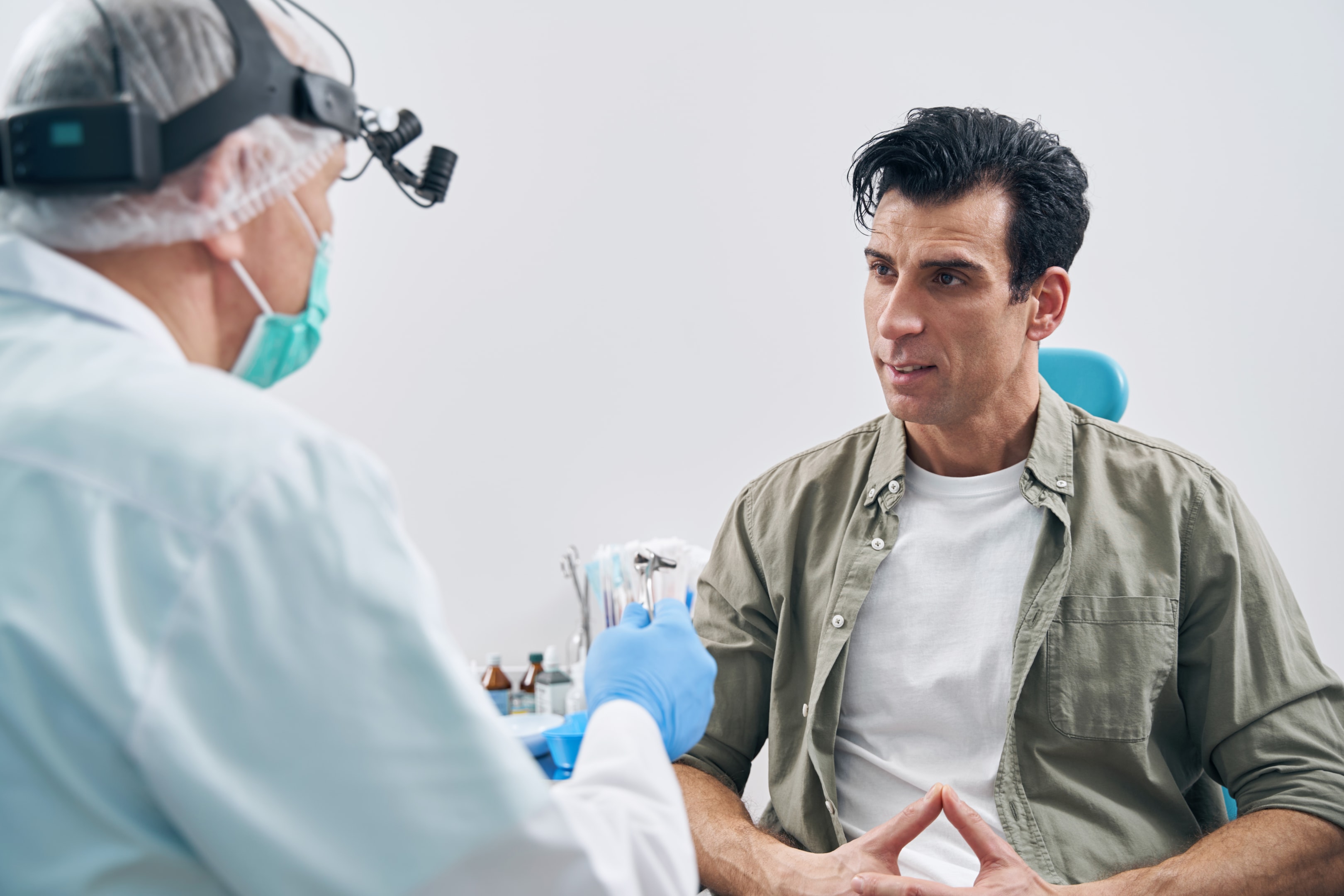 a surgeon speaking to a patient about his upper jaw and the impact corrective jaw surgery can have
