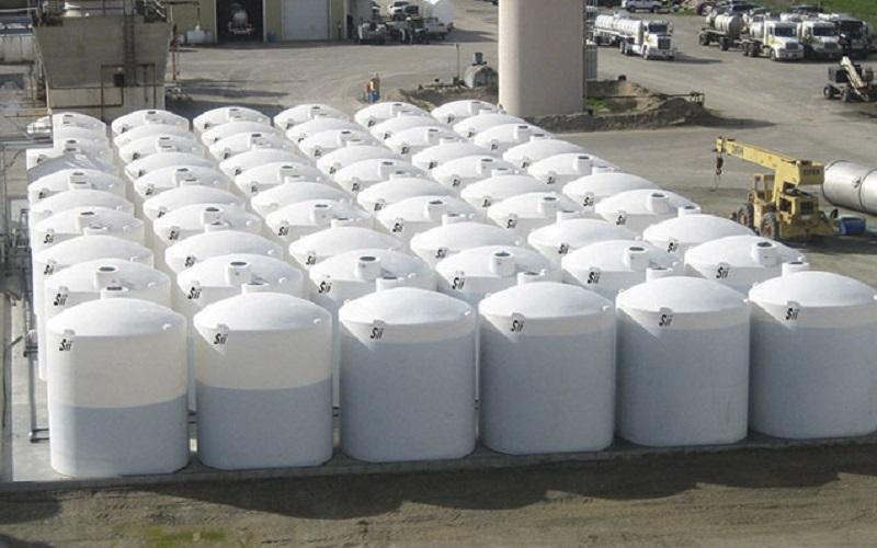 Large HDPE chemical storage tanks used in industrial settings for storing acids and other chemicals