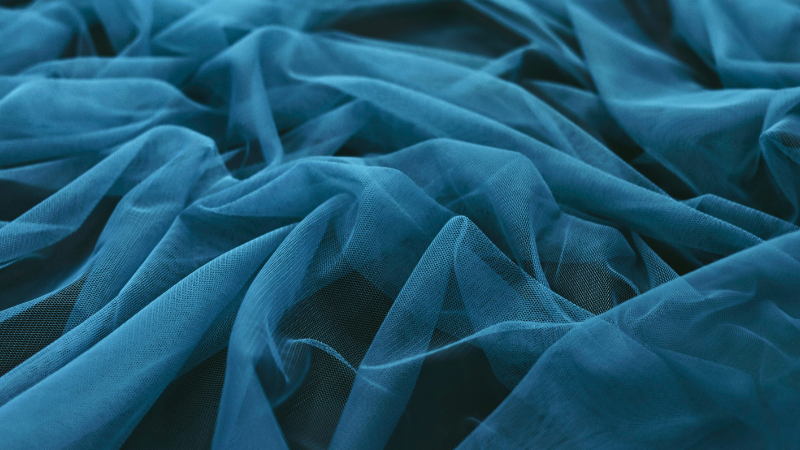 A close-up view of a blue sheer fabric