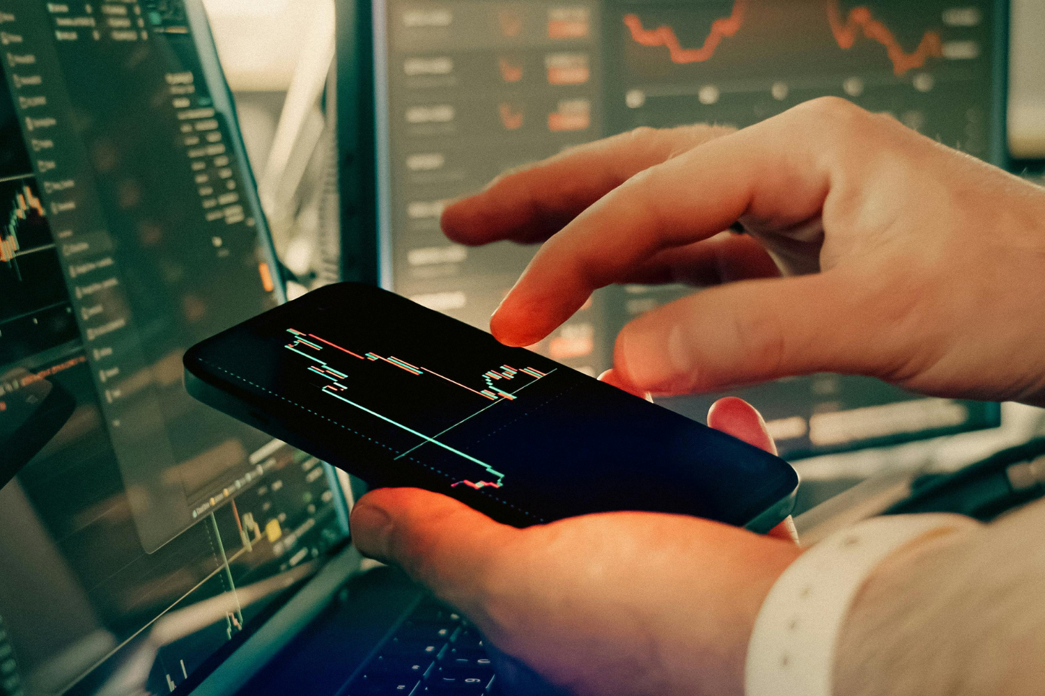 Business owner reviewing market data and performance metrics on a screen.