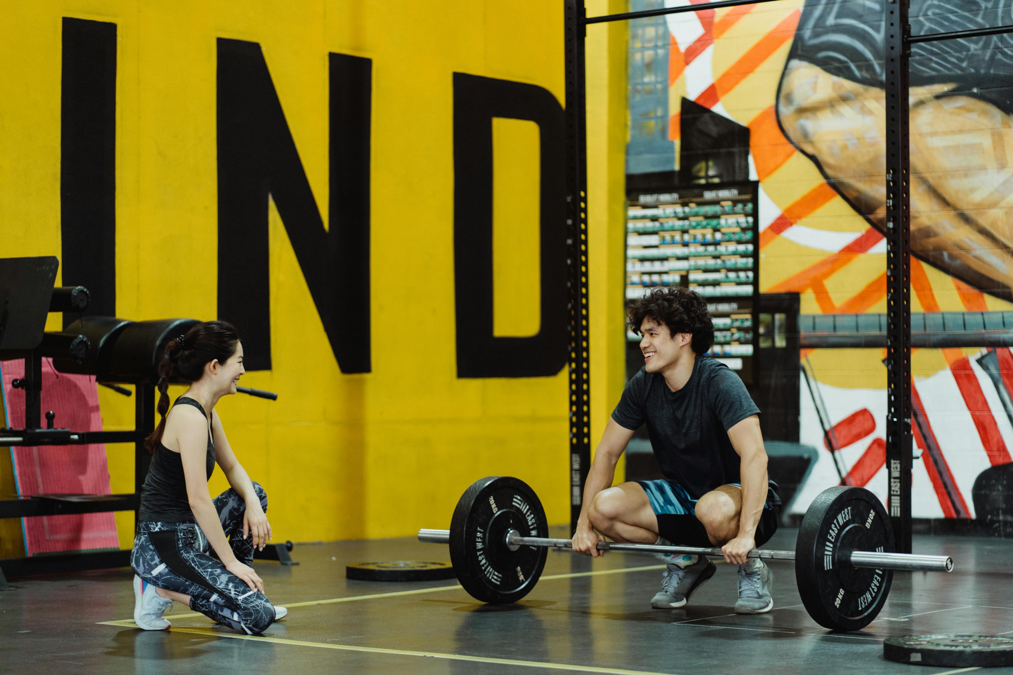 Photo by Ketut Subiyanto: https://www.pexels.com/photo/a-man-holding-a-barbell-on-the-floor-in-front-of-a-woman-4853279/