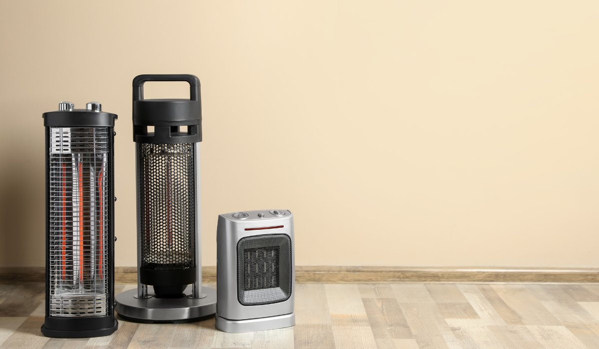 Portable electric heaters - a ceramic heater with two convector heaters on hardwood floor