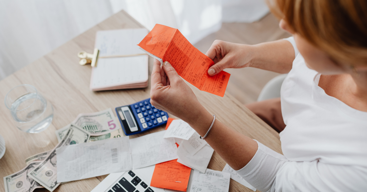 Woman organizing receipts for child tax credit refund date 2025 and tax deductions.