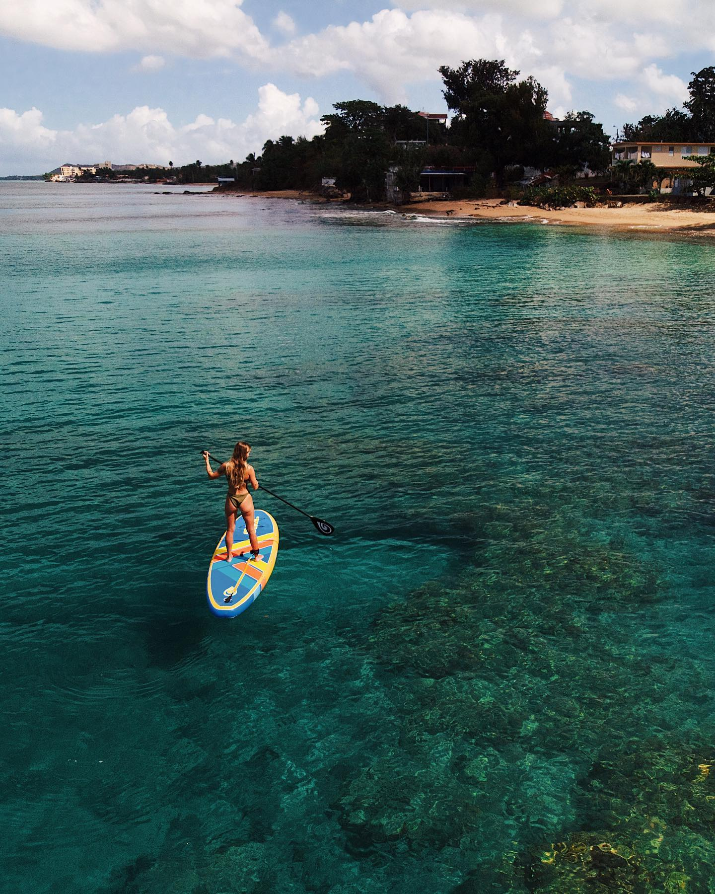 woman on an inflatable paddle board