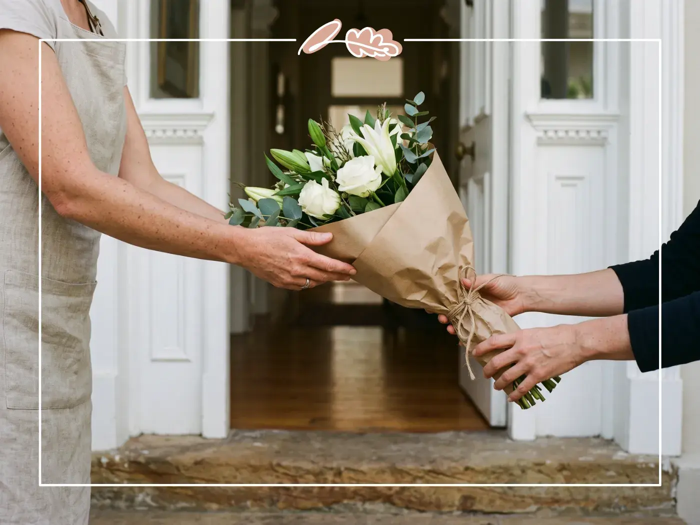 Florist hand-delivering a wrapped white sympathy bouquet to a recipient at the front door, Fabulous Flowers Cape Town