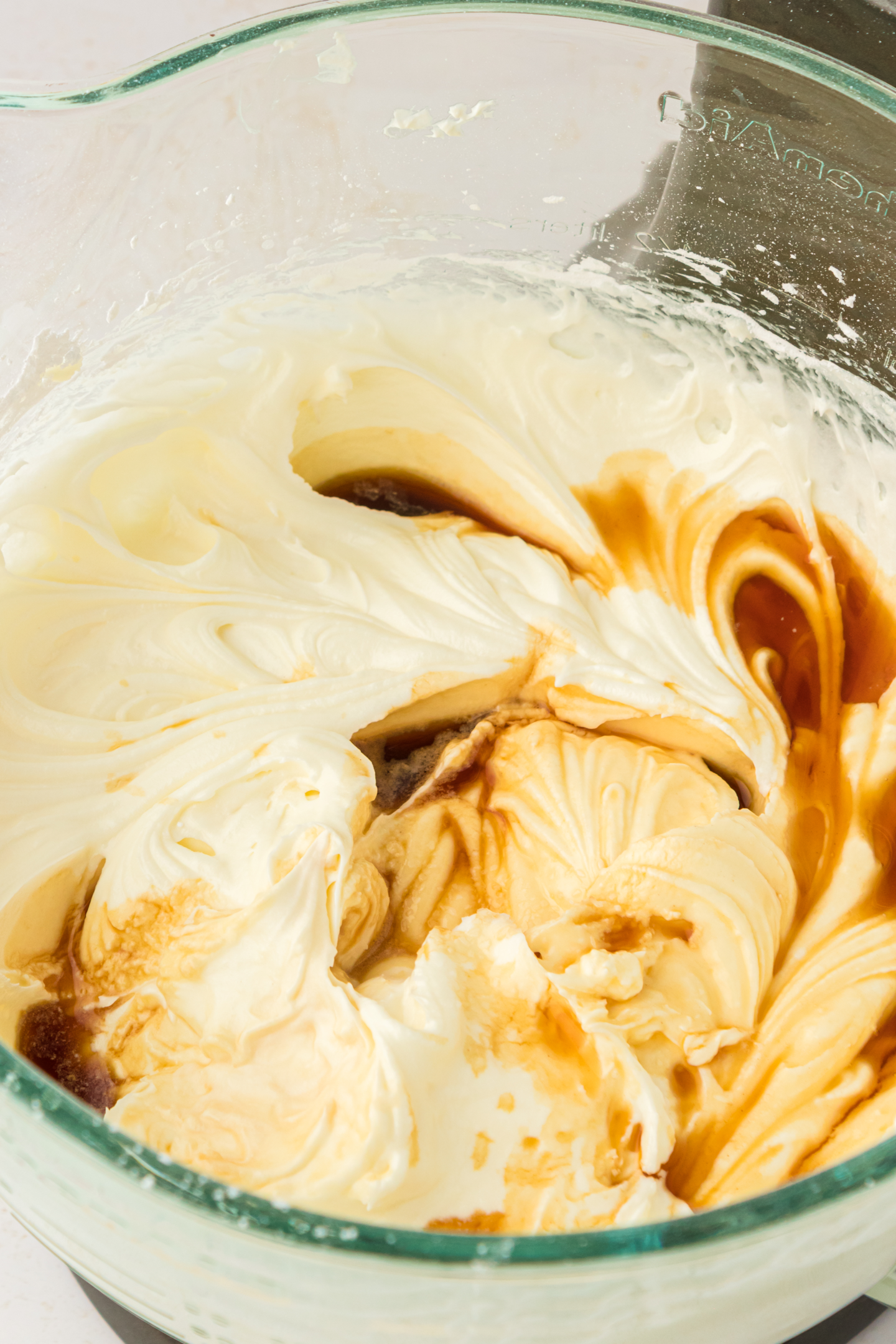 vanilla extract added to large bowl of cream cheese frosting