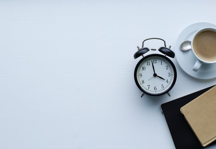 Clock with coffee and notebooks