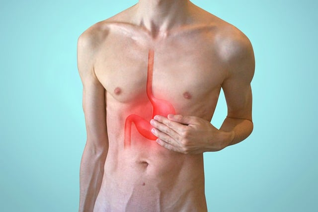 A graphical image of a male torso with reddened esophagus and stomach, symbolizing acid reflux. 
