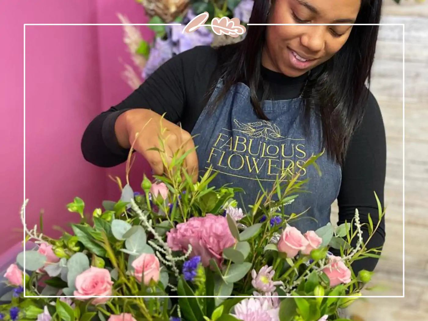 A florist from Fabulous Flowers and Gifts arranging a bouquet of pink and green flowers with a smile. Your Perfect Bouquet of Flowers.