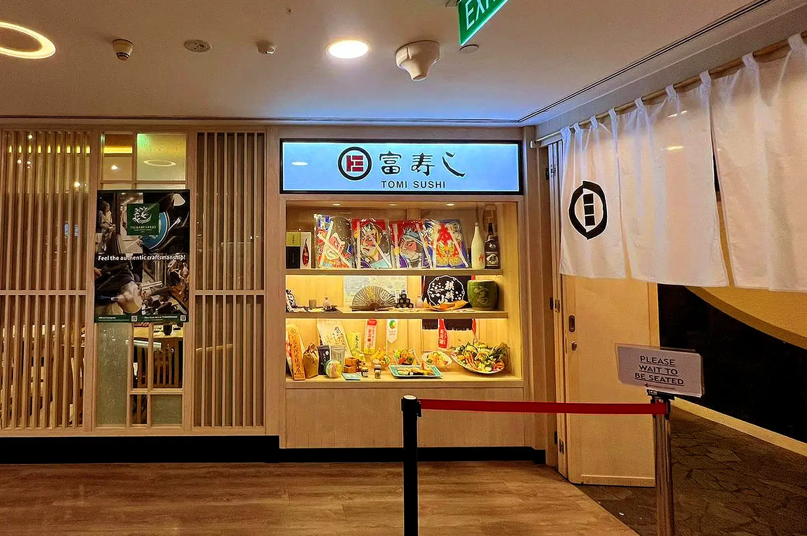 Tomi Sushi Singapore Japanese restaurant entrance with traditional décor and sushi display