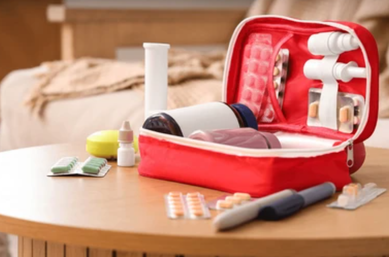 Open first aid kit with medical supplies on table