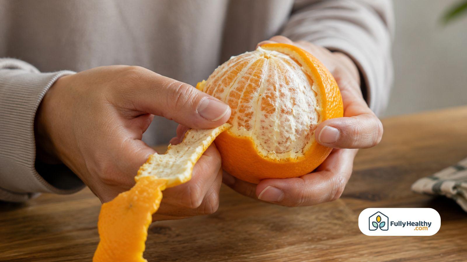 Hands peeling a fresh orange.