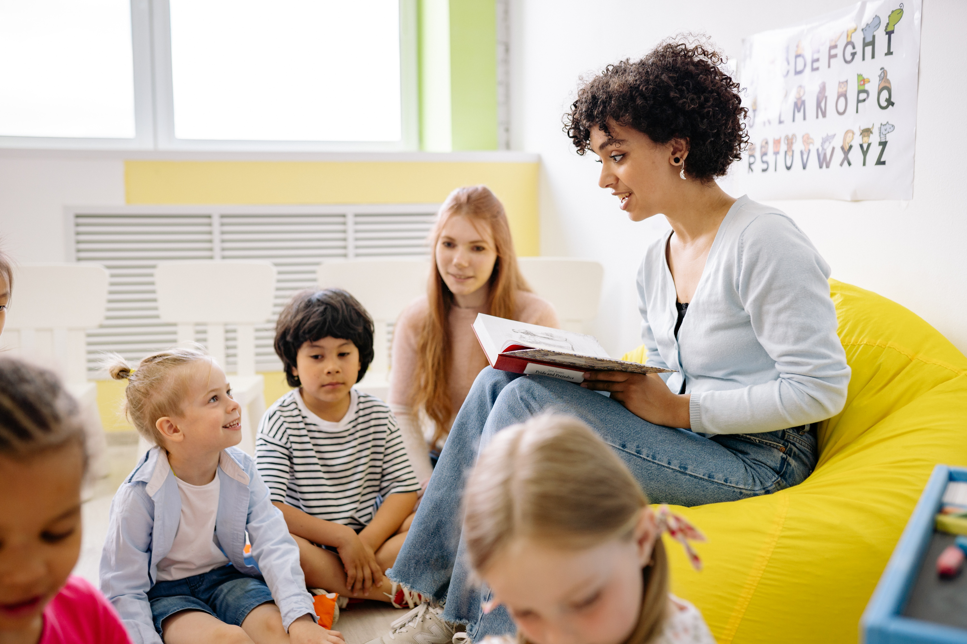 A teacher reading to children.