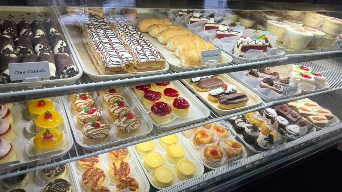 Artuso’s Pastry Shop display case showing pasteries and cakes