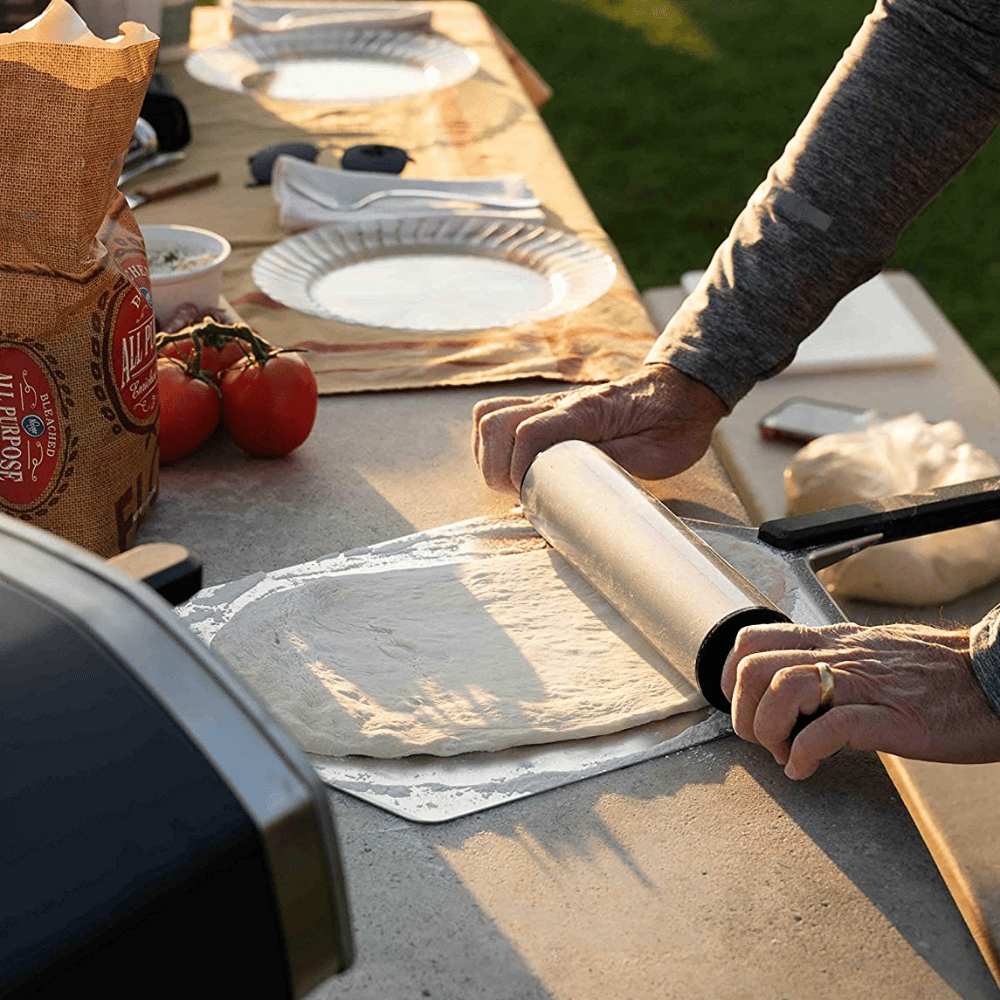 Rolling out pizza dough on the Ooni Pizza peel