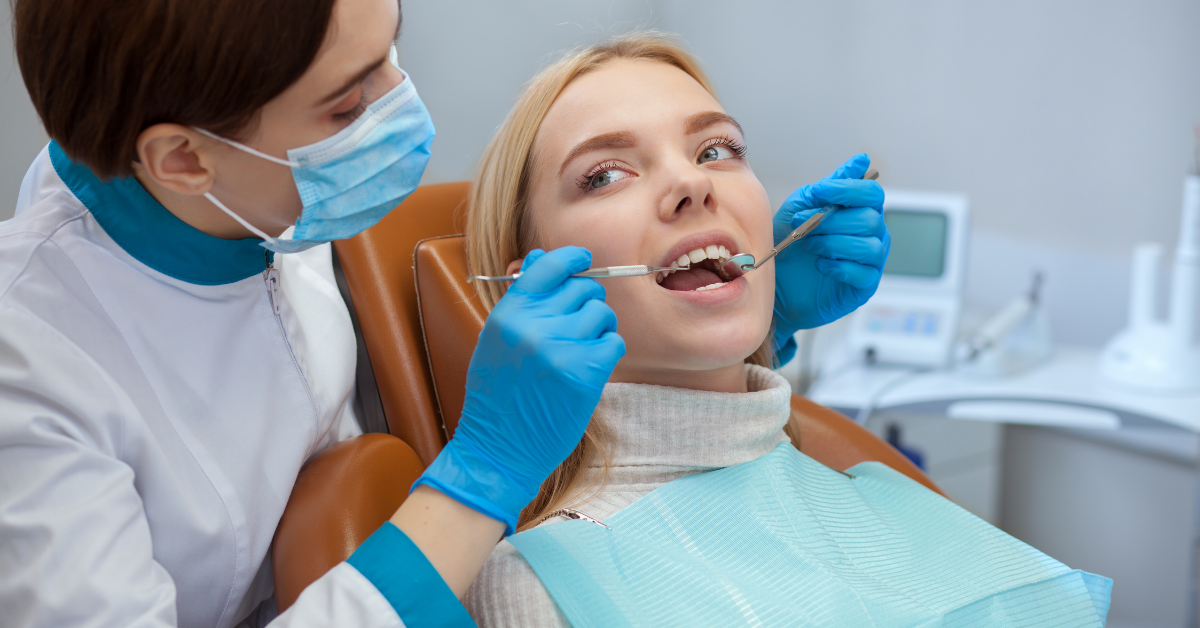 A high-quality image of a dentist performing a cleaning on a patient.
