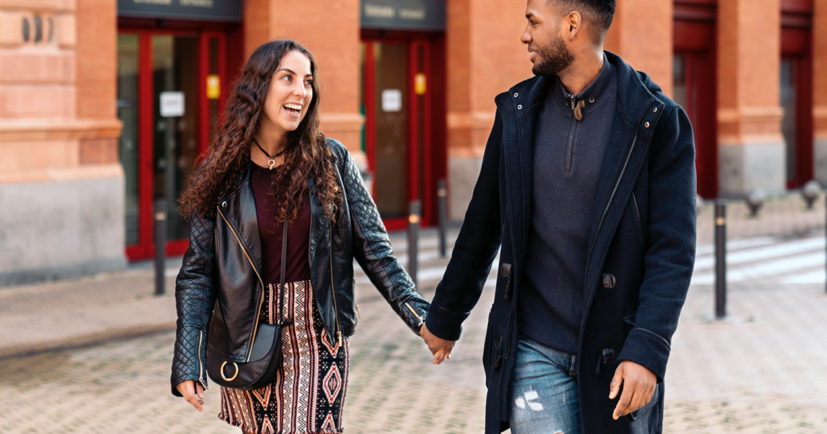 Happy couple holding hands in New York City, symbolizing the success of couples therapy at Loving at Your Best Marriage and Couples Counseling.