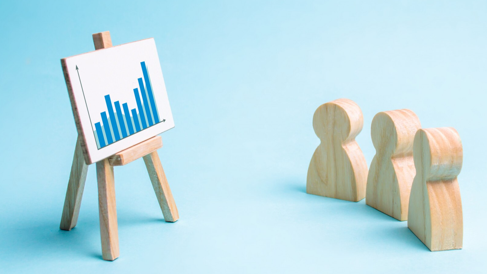 Wooden figures viewing a blue bar chart, reflecting how generalist firms apply traditional marketing strategies to the telecom industry.