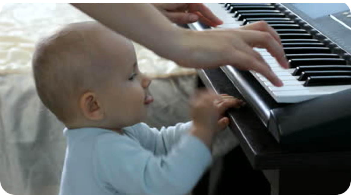 A baby Learning through games with the piano.