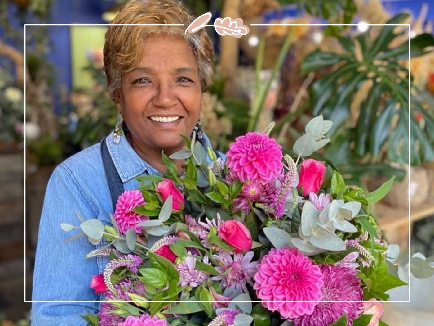 Woman smiling while holding a bouquet of pink flowers - Fabulous Flowers and Gifts