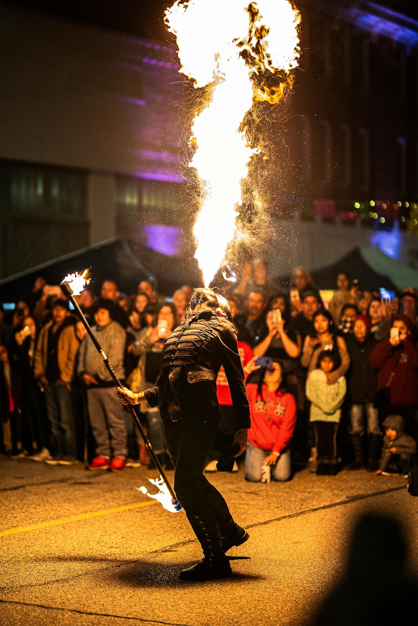 Fun facts about mexico - A fire performer breathing flames at a lively night event. 