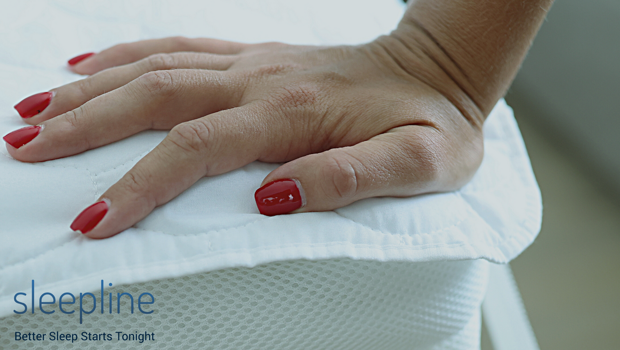 Woman's hand on a mattress pad