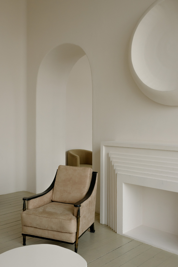 a chair in a white room with architectural details