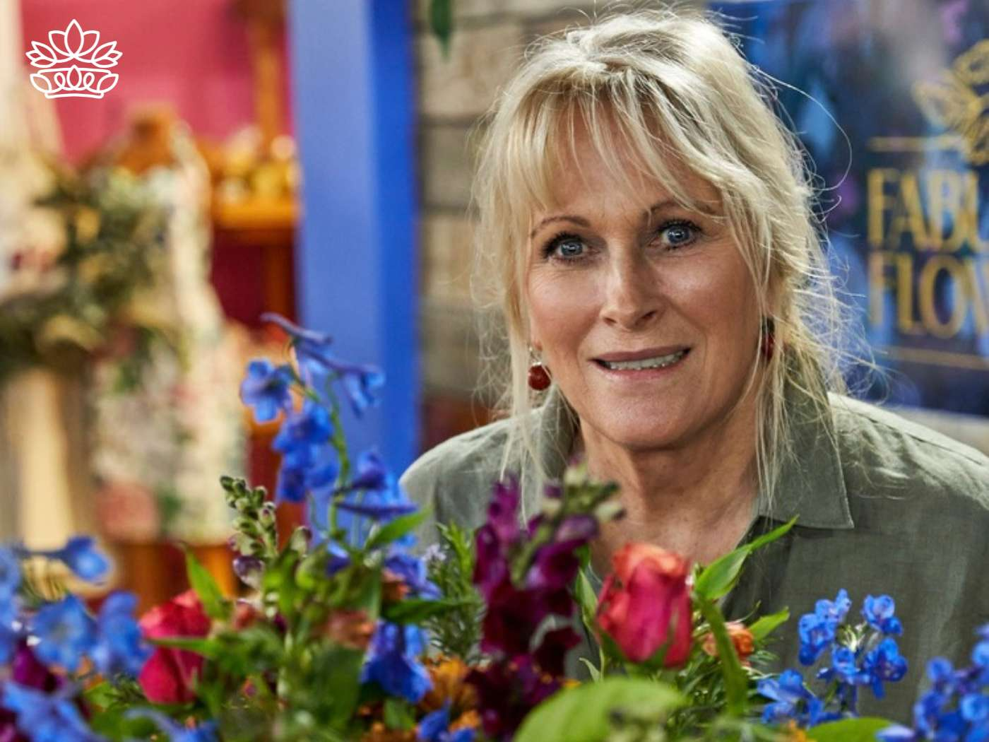 Friendly florist with a welcoming smile arranging a vibrant selection in a flower arrangement, crafting beauty at Fabulous Flowers and Gifts.