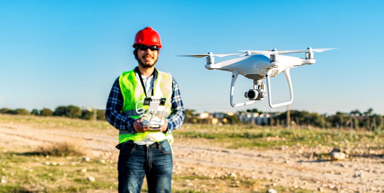 A drone pilot operating a drone for aerial photography.